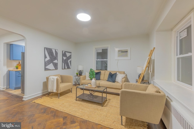 living room featuring parquet floors and radiator