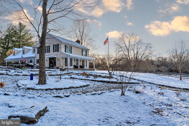 view of snow covered rear of property