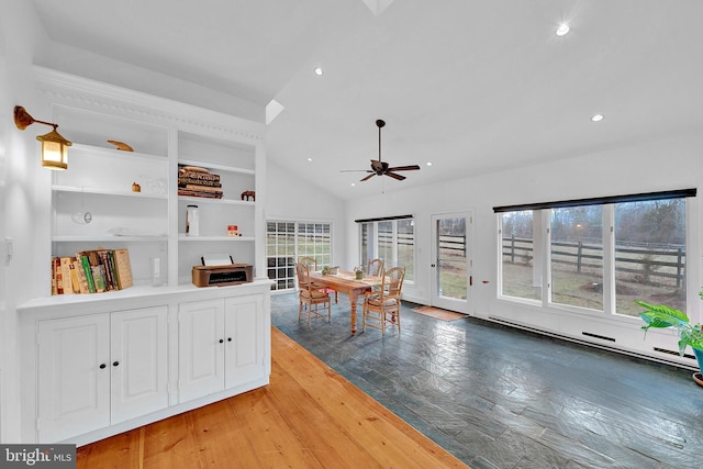 interior space featuring vaulted ceiling, hardwood / wood-style flooring, ceiling fan, built in features, and a baseboard radiator