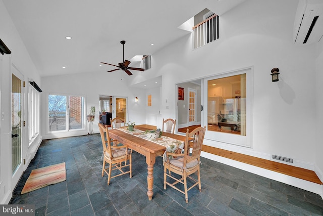 dining room featuring ceiling fan, a wall unit AC, high vaulted ceiling, and french doors