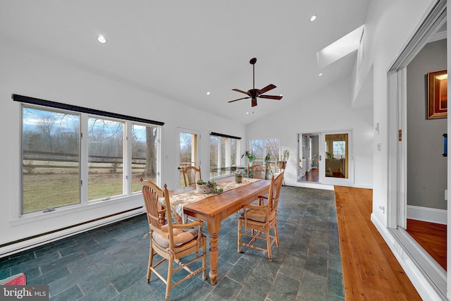 dining space with ceiling fan, high vaulted ceiling, and a baseboard radiator