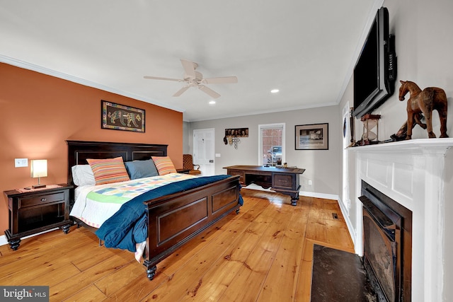 bedroom with ceiling fan, crown molding, and light hardwood / wood-style flooring