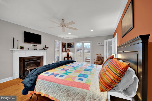 bedroom featuring ceiling fan, light hardwood / wood-style flooring, and crown molding