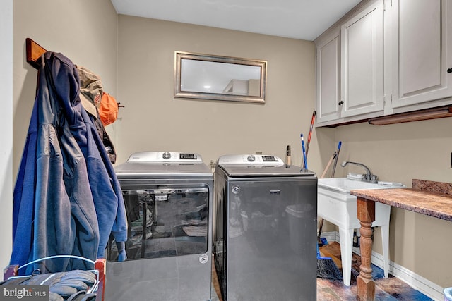 laundry room featuring cabinets and washing machine and dryer