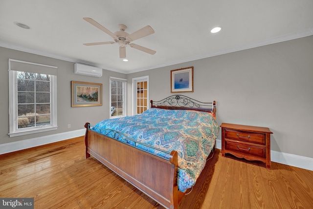 bedroom with ceiling fan, crown molding, a wall unit AC, and light hardwood / wood-style flooring