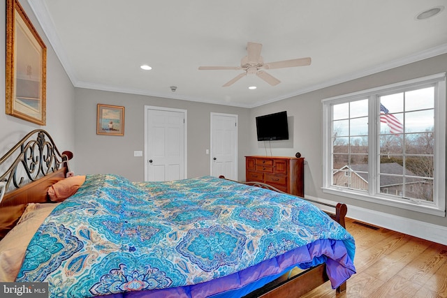 bedroom with wood-type flooring, ceiling fan, and ornamental molding