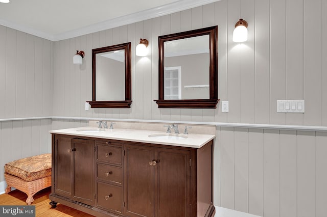 bathroom featuring crown molding, vanity, and hardwood / wood-style flooring