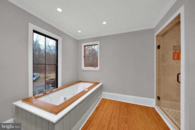 bathroom with hardwood / wood-style floors, separate shower and tub, and ornamental molding