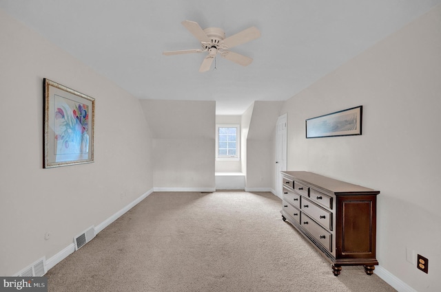 bonus room featuring ceiling fan and light colored carpet