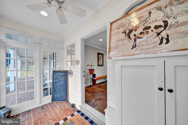 interior space featuring ceiling fan and crown molding