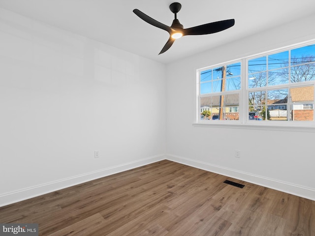 unfurnished room with ceiling fan and hardwood / wood-style flooring