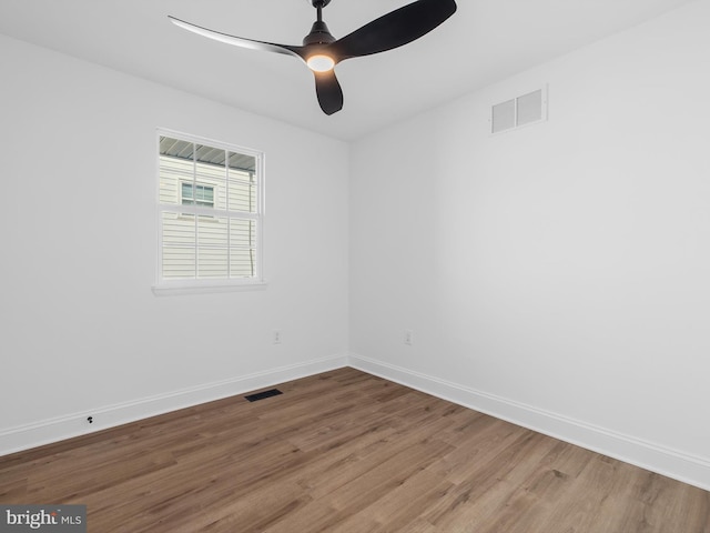 empty room featuring ceiling fan and hardwood / wood-style flooring