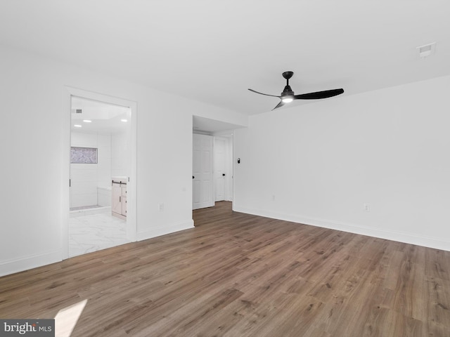 spare room with light hardwood / wood-style floors and ceiling fan