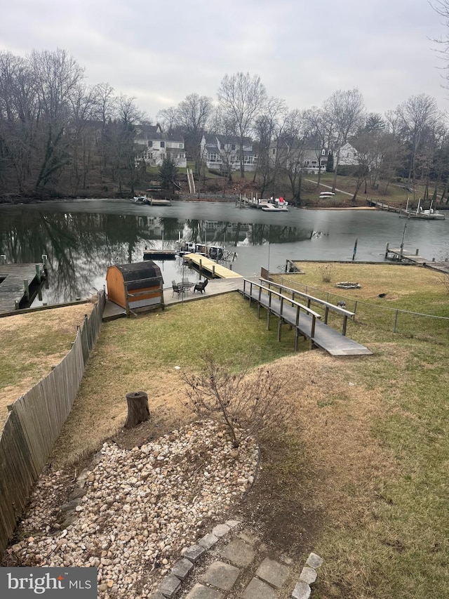 dock area featuring a water view and a yard