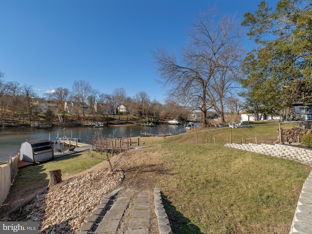 view of yard with a boat dock and a water view