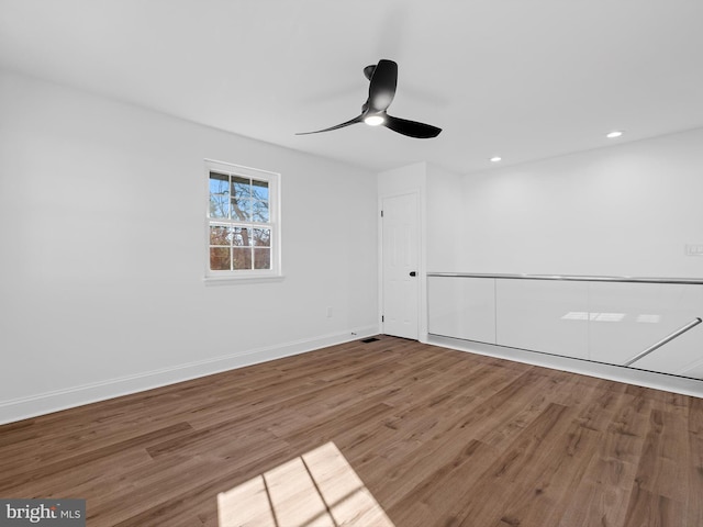 spare room with hardwood / wood-style floors and ceiling fan