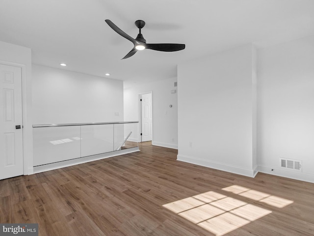 empty room with hardwood / wood-style flooring and ceiling fan