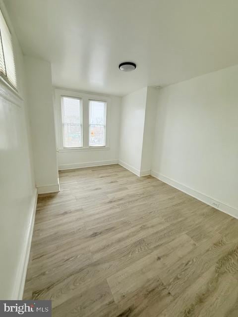 spare room with light hardwood / wood-style flooring