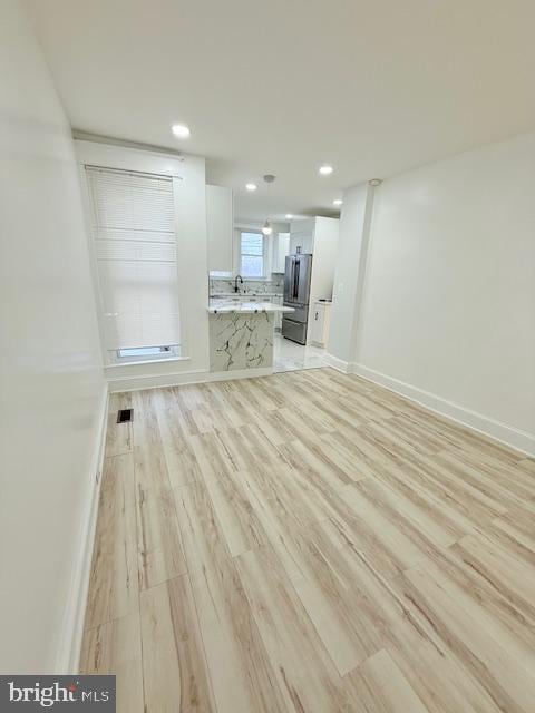 unfurnished living room featuring light hardwood / wood-style floors