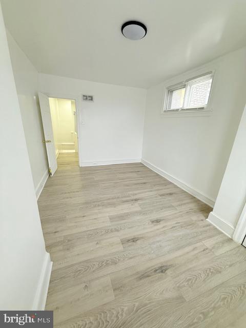 spare room featuring light hardwood / wood-style floors