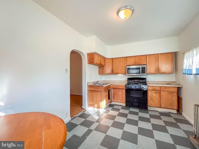 kitchen featuring black gas stove and sink