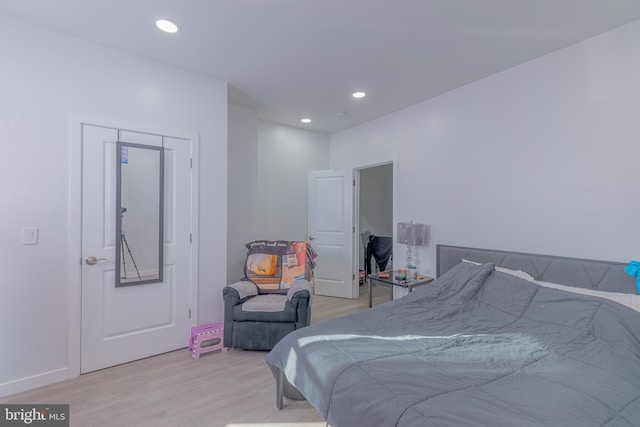 bedroom featuring light wood-type flooring and a closet