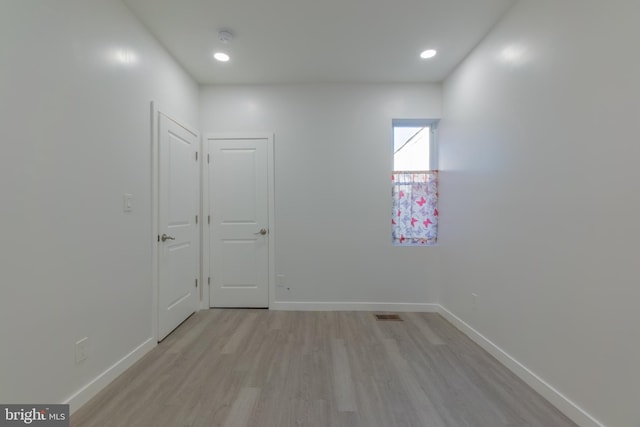 spare room featuring light hardwood / wood-style flooring