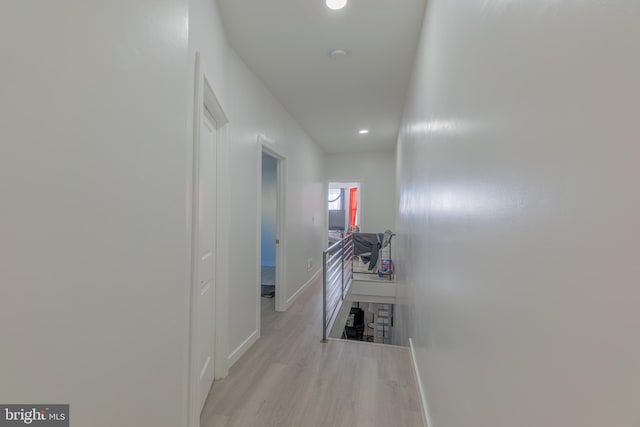 hallway with light hardwood / wood-style flooring