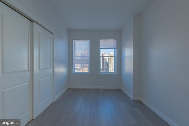 unfurnished bedroom with a closet and light hardwood / wood-style flooring