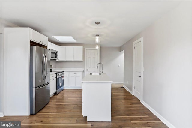 kitchen with sink, dark hardwood / wood-style floors, an island with sink, white cabinetry, and stainless steel appliances