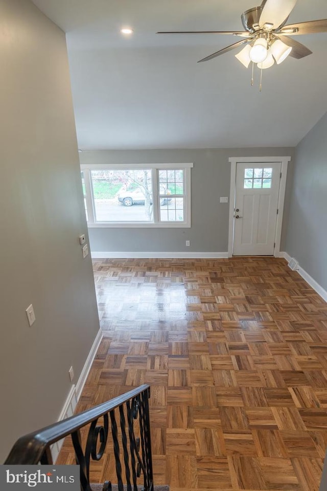 entrance foyer with ceiling fan and parquet floors