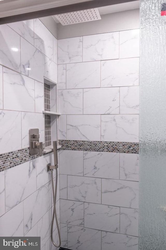 bathroom with a tile shower