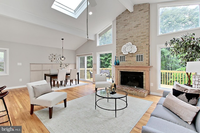 5284 Davis Ford Rd, Woodbridge, VA 22192 - living area featuring beam ceiling, high vaulted ceiling, wood finished floors, a skylight, and baseboards