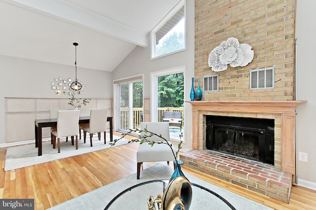 5284 Davis Ford Rd, Woodbridge, VA 22192 - living room with wood finished floors, beamed ceiling, a fireplace, baseboards, and high vaulted ceiling