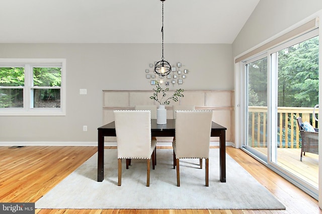 5284 Davis Ford Rd, Woodbridge, VA 22192 - dining space featuring light wood-type flooring, healthy amount of natural light, vaulted ceiling, and baseboards