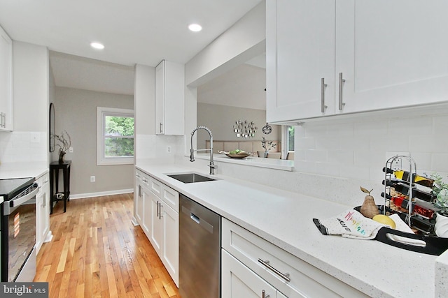 5284 Davis Ford Rd, Woodbridge, VA 22192 - kitchen featuring appliances with stainless steel finishes, a sink, light countertops, white cabinets, and decorative backsplash