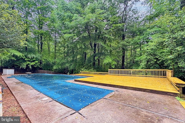 5284 Davis Ford Rd, Woodbridge, VA 22192 - view of pool with a covered pool, a wooden deck, a diving board, fence, and a patio area