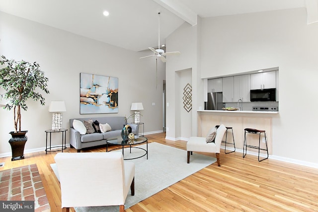5284 Davis Ford Rd, Woodbridge, VA 22192 - living room with beamed ceiling, light wood-style floors, ceiling fan, baseboards, and high vaulted ceiling