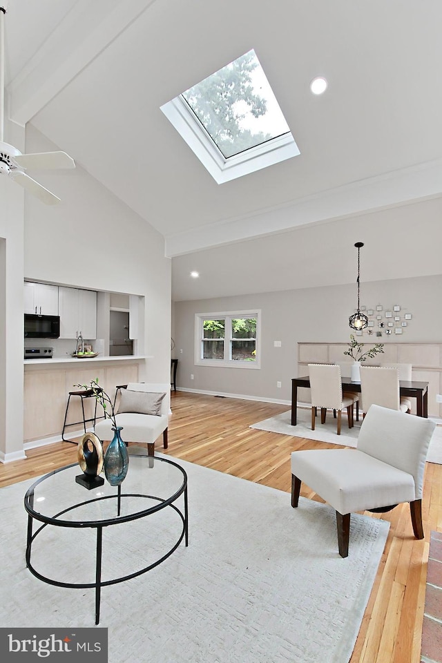5284 Davis Ford Rd, Woodbridge, VA 22192 - living room with light wood-type flooring, baseboards, high vaulted ceiling, a skylight, and beam ceiling