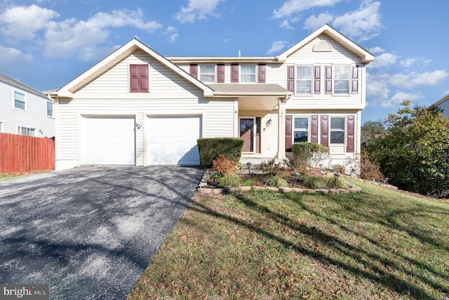 view of front facade with a garage and a front lawn