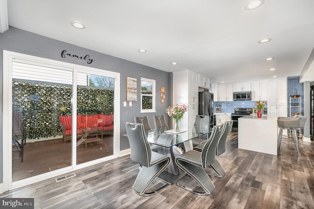 dining space featuring dark hardwood / wood-style floors