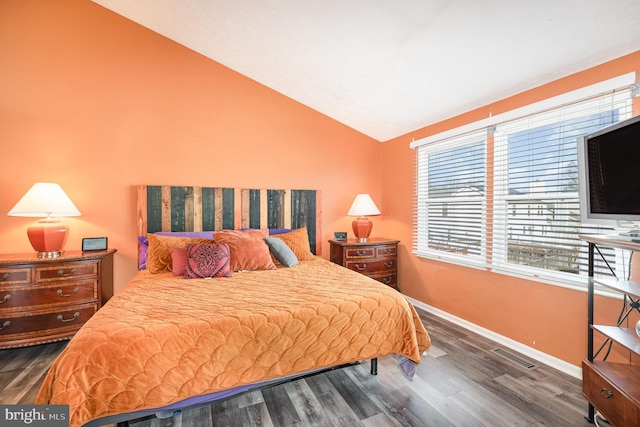 bedroom featuring vaulted ceiling and dark hardwood / wood-style flooring