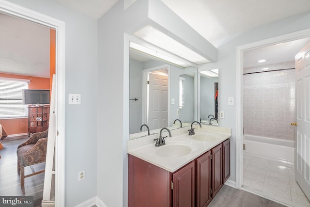 bathroom featuring vanity, hardwood / wood-style flooring, and  shower combination