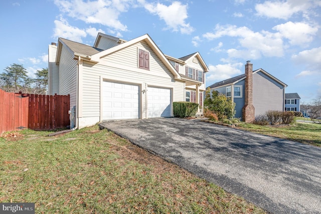 view of front property featuring a garage and a front yard