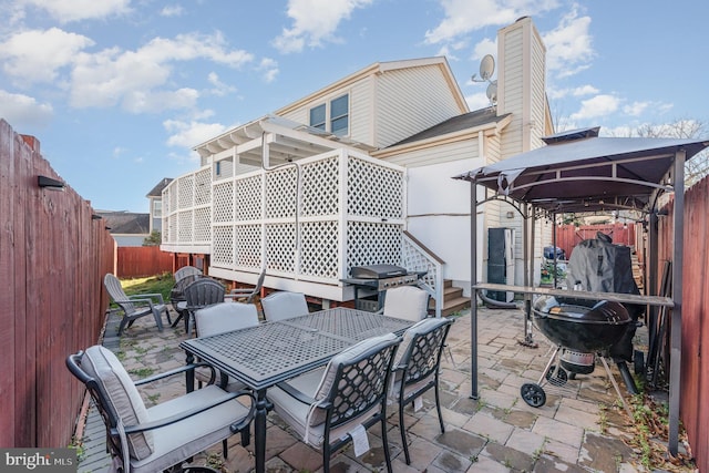 view of patio featuring a gazebo and a grill