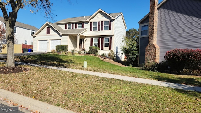 view of front of house with a garage and a front lawn