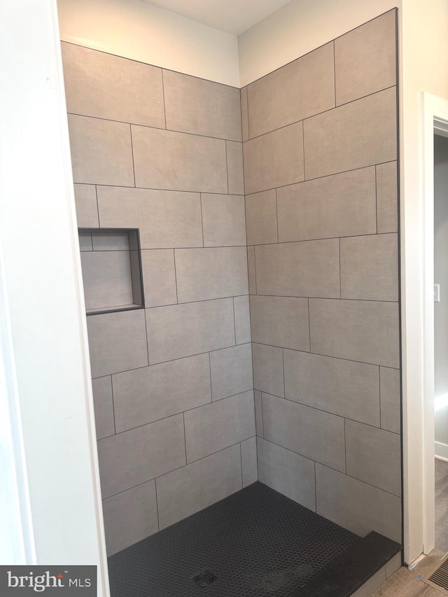 bathroom with a tile shower