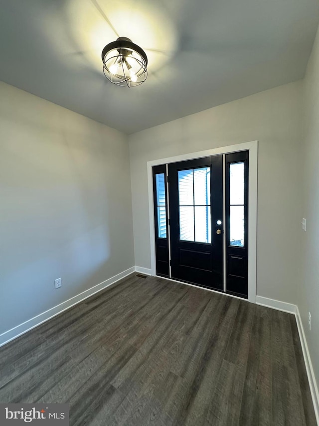 entryway with baseboards and dark wood-type flooring