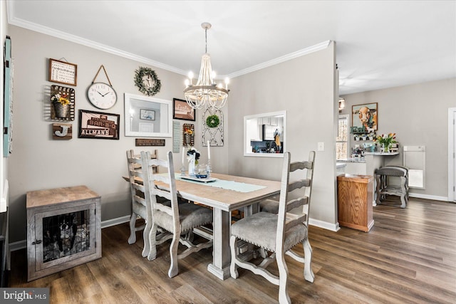 dining space with crown molding, dark hardwood / wood-style floors, and a notable chandelier