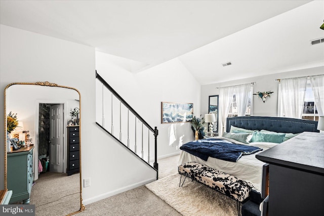 carpeted bedroom with vaulted ceiling